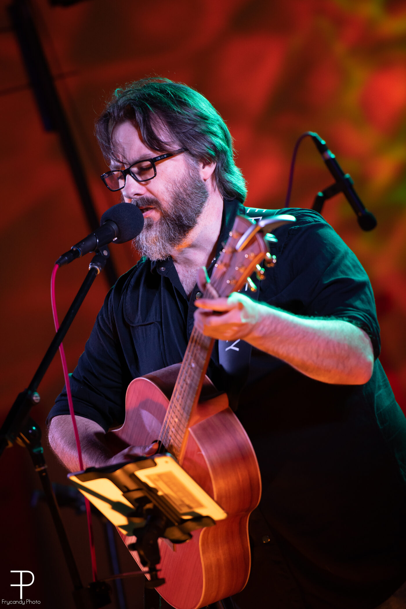 AJ Patrick performing under stage lighting